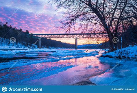 Icy Delaware River Reflects The Vivid Sunset Near Milford Bridge Pa