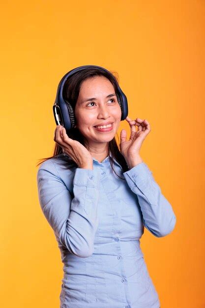 Premium Photo Cheerful Filipino Woman Listening Music And Dancing