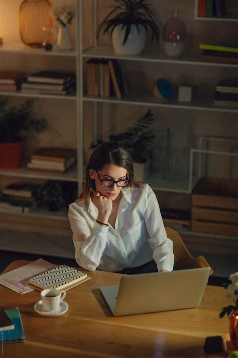 Businesswoman Working Late At Her Office By Stocksy Contributor Lumina Stocksy