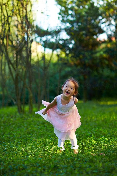 Lovely Little Asian Girl In Garden By Stocksy Contributor Bo Bo Stocksy