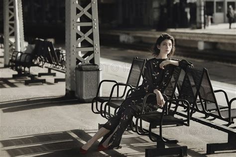 Caucasian Woman Sitting On Bench At Train Station Photo12 Tetra Images Ivan Ozerov
