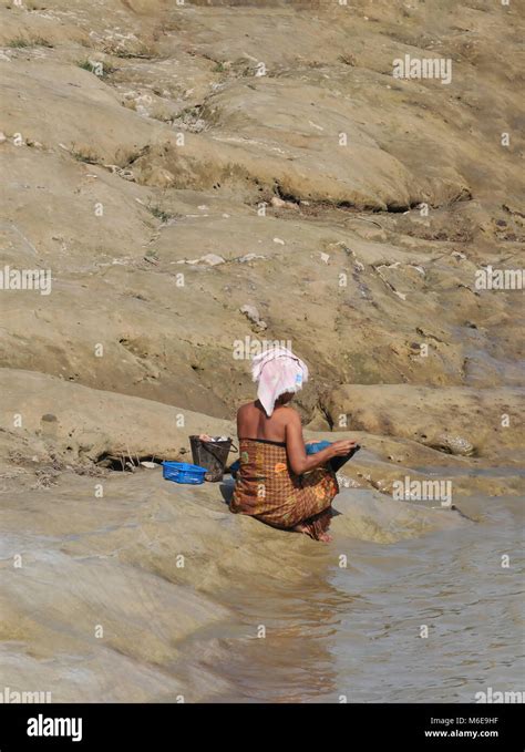 A Woman Bathing Near The Banks Of The Irrawaddy River In Myanmar Burma