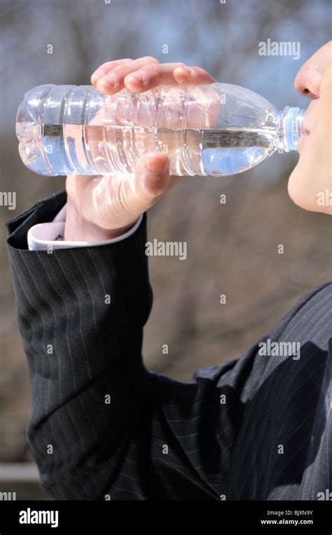 Young Man Drinking Mineral Water Stock Photo Alamy