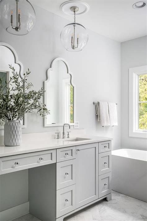 A cool minimalist grey bathroom with grey terrazzo in the shower, a white vanity and windows for natural light. Light Gray and White Master Bath Colors - Transitional ...