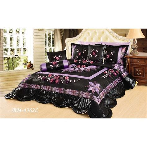 Black And Purple Bedding With Flowers On It