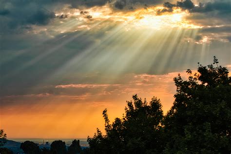 Rays Of Light Shining Through The Clouds On A Hazy Summer Day Rpics