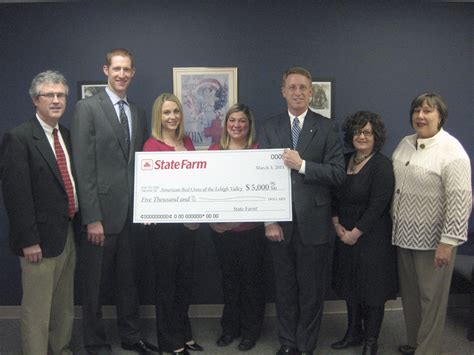 State Farm Erie Insurance Present Checks To American Red Cross For