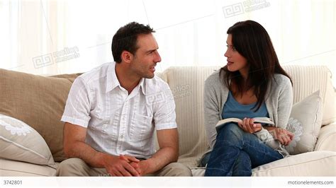 Parents Talking Each Other Sitting On The Sofa Stock Video Footage