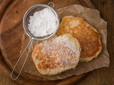 Homemade Pancakes With Powdered Sugar On Wooden Table Stock Photo