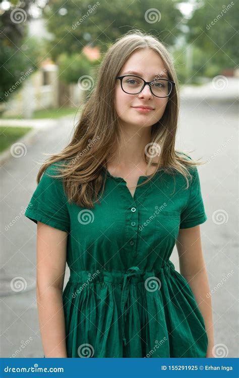 Portrait Of Confident Young Girl With Eyeglasses Smiling Blonde Hair