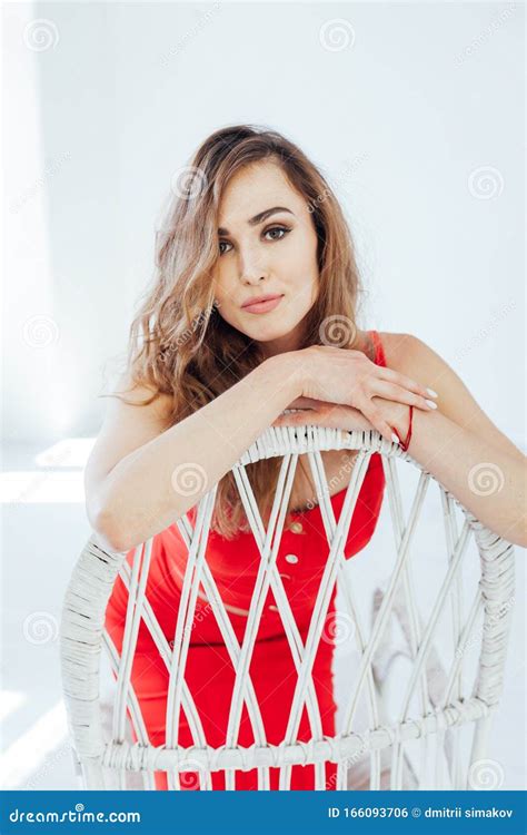 Beautiful Fashionable Blonde Woman In Red Dress In The Room Stock Photo