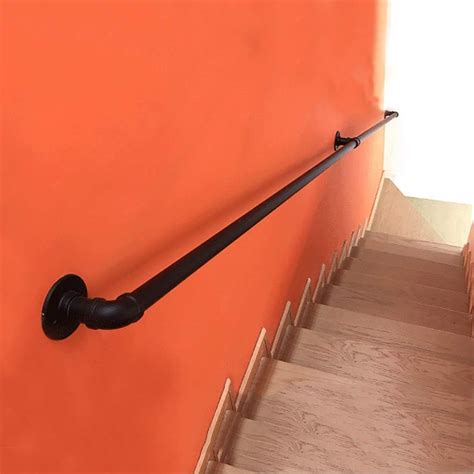 Black Metal Wrought Iron External Outside Handrail Against The Wall