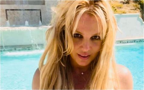 britney spears goes topless in bright yellow bikini bottoms for sexy poolside photos pics inside