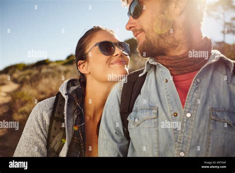 Young Happy Hiking Couple Looking At Each Other Smiling Young Caucasian Couple On Hike Enjoying