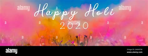 Happy Holi 2020 Text Over Crowd Throwing Bright Colored Powder Paint In