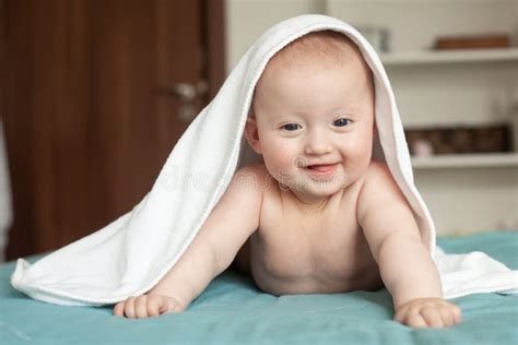 Baby Smiling Laughingcute Baby Lying On Her Tummy Over A White Towel