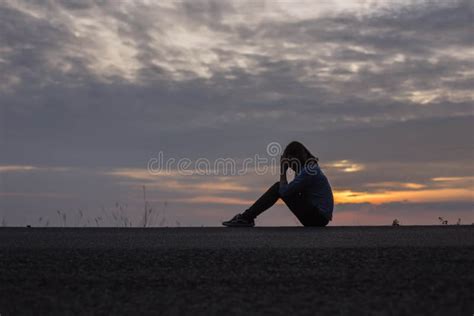 Silhouette Of Lonely Depressed And Sad Woman Cry And Hug Her Knees