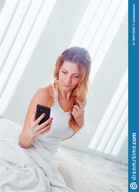 Young Beautiful Woman Taking A Selfie On Her Phone In Bed After Wake Up Stock Image Image Of