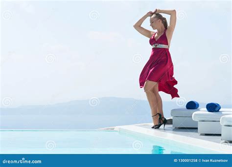 Attractive Girl In Red Dress Posing Near The Pool Stock Photo Image