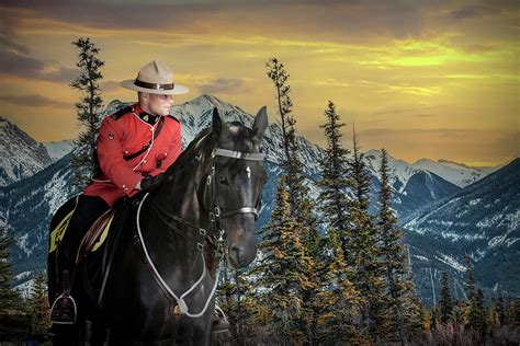 Royal Canadian Mounted Police On Horse Back In The Mountains Photograph