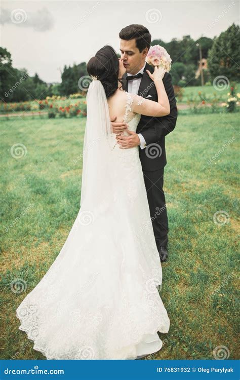Romantic Fairytale Happy Newlywed Couple Hugging And Kissing In A