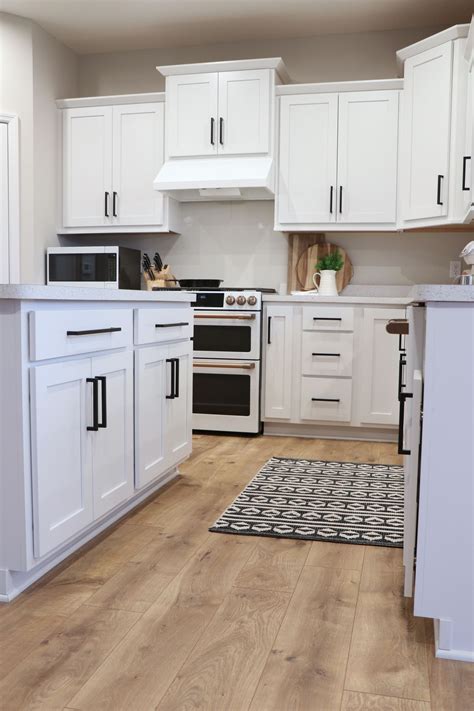 The best finishing touch on a contemporary kitchen is sleek cabinet pulls. Modern farmhouse kitchen, with white cabinets and black ...