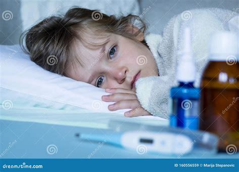 Exhausted Sick Child With Fever Lying In Bed Healthcare And Medical