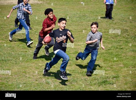Young teens playing football in the park Stock Photo - Alamy