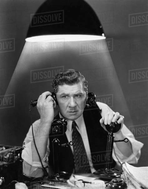Man Using Two Telephones Stock Photo Dissolve