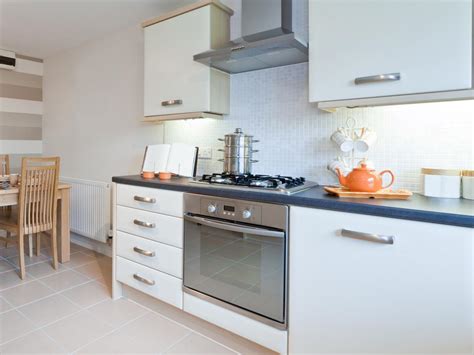 This is a modern kitchen design with basic wengue kitchen cabinets topped with white solid surface. Small Kitchen Cabinets: Pictures, Options, Tips & Ideas | HGTV