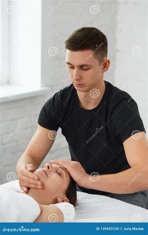 Professional Massage Therapist Is Treating A Female Patient In Apartment Stock Image Image Of