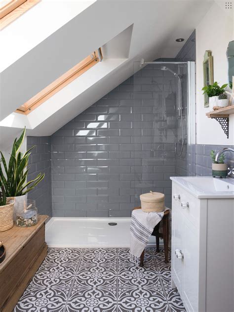 An oval bath cuts corners to boost the impression of space. Tons of tiles tiles | Loft conversion bedroom, Loft ...
