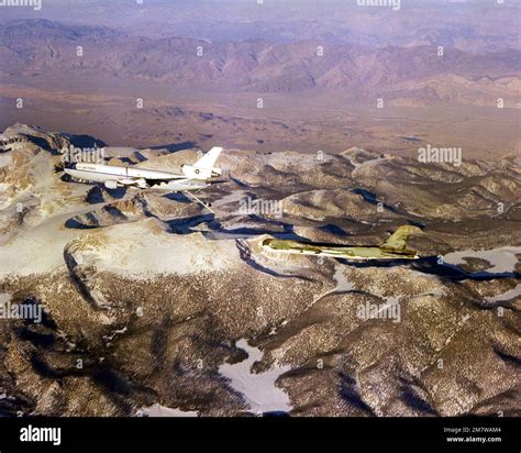 Left side view of a KC-10A Extender aircraft refueling a B-52