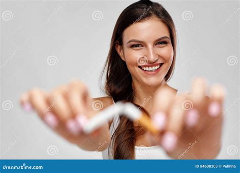 Beautiful Happy Female With Broken Cigarette Quitting To Smoke Stock