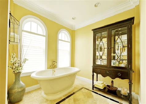This richly detailed bathroom gets a lift from warm yellow paint above a marble tile wall treatment. 15 Charming Yellow Bathroom Design Ideas | Home Design Lover
