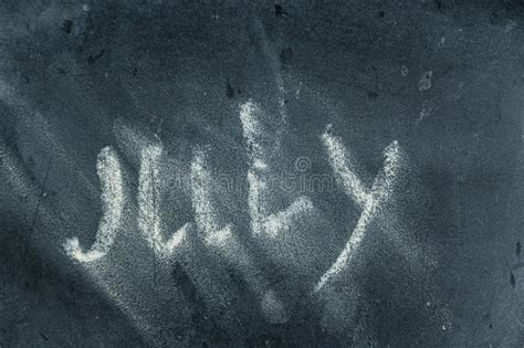 Semi Erased Word July On Black Chalkboard Handwritten Word Fuzzy