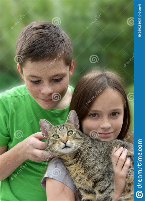 Siblings Play And Cuddle With Their Little Cat Stock Image Image Of