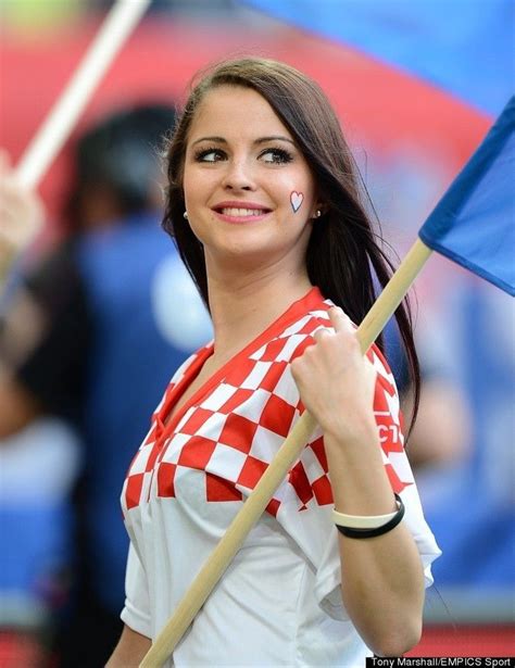 A Woman Holding A Blue And White Checkered Flag In Her Hand While