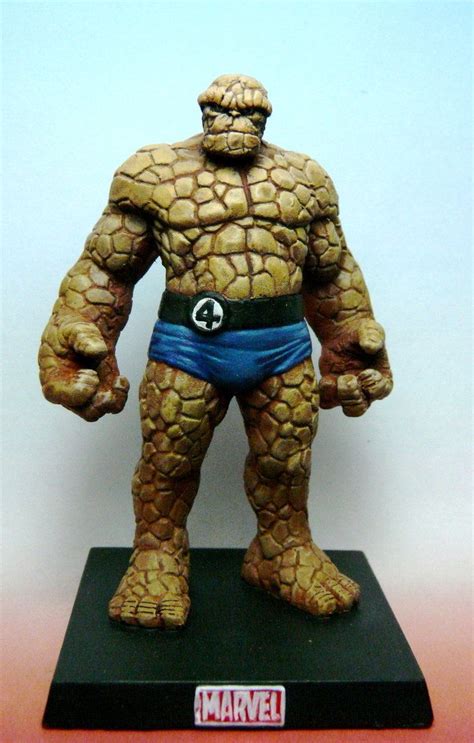 A Statue Of The Thing Man Is Displayed On A Stand