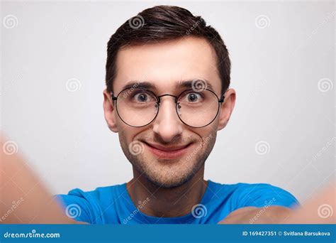 Close Up The Astonished Face Of A Young White Man With Glasses Stock