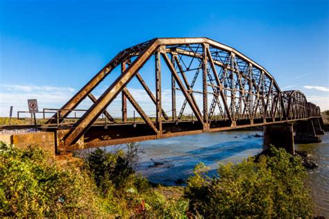 An Iconic Old Metal Truss Railroad Bridge Over A Large River