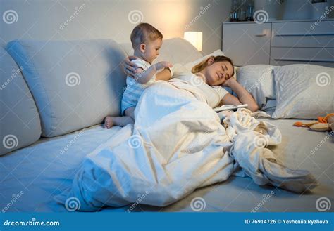 Mother Trying To Sleep While Her Baby Waking Her Up Stock Photo Image