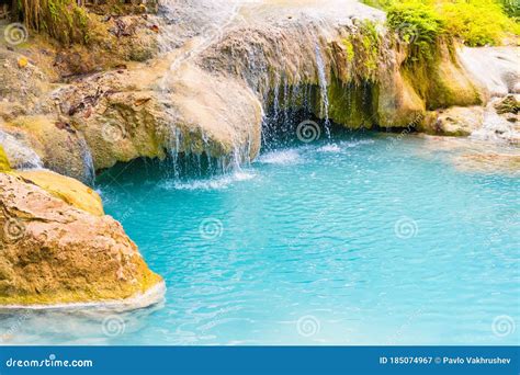 Tropical Waterfall With Emerald Blue Lake And Rocks In Jungle Forest