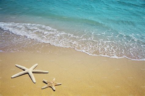 Two Starfish On Beach Sand And Sea Featuring Sea Starfish And Beach