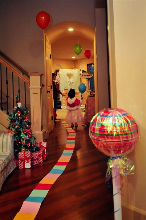 A Woman In A Pink Dress Is Walking Down The Hallway With Presents On
