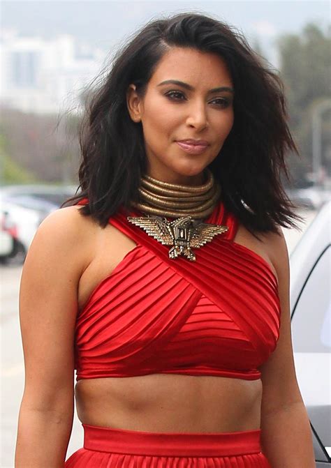 kim kardashian shows off tiny toned waist in sexy red crop top matching floor length skirt at