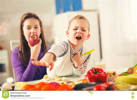 Boy And Girl Preparing And Eating Meal Stock Image Image Of Cooking