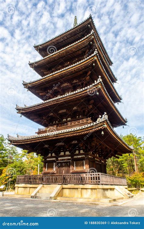 Brown Wooden Five Storied Buddhist Pagoda With Blue Sky In Autumn In