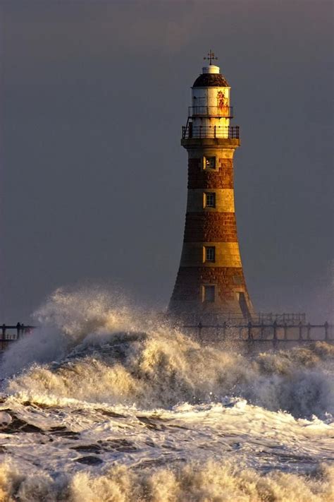 Waves Crashing Against A Lighthouse Tyne And Wear England