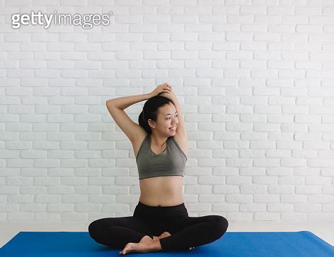 Asian Women Play Yoga At Home With White Brick Wall Background Exercise For Lose Weight